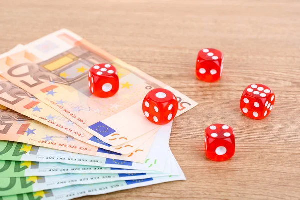 Red dices and money, on wooden background — Stock Photo, Image