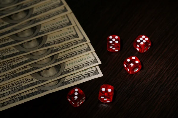 Red dices and dollars on wooden background — Stock Photo, Image