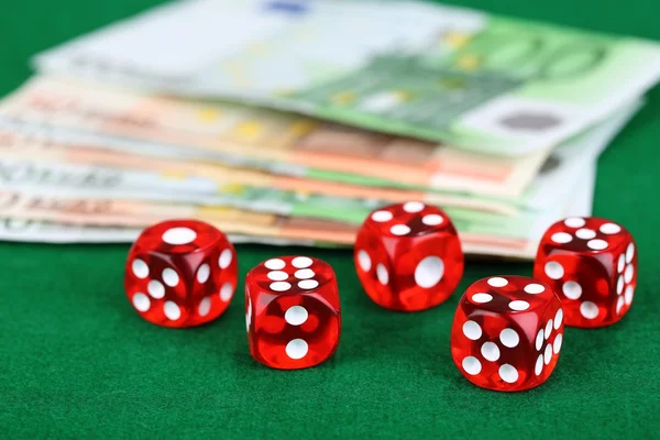 Red dices and money, on green background — Stock Photo, Image