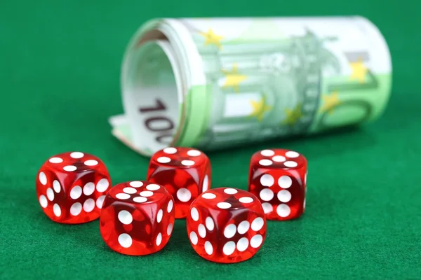 Red dices and money, on green background — Stock Photo, Image