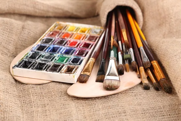 Composition with brushes, watercolors on wooden palette, isolated on white — Stock Photo, Image