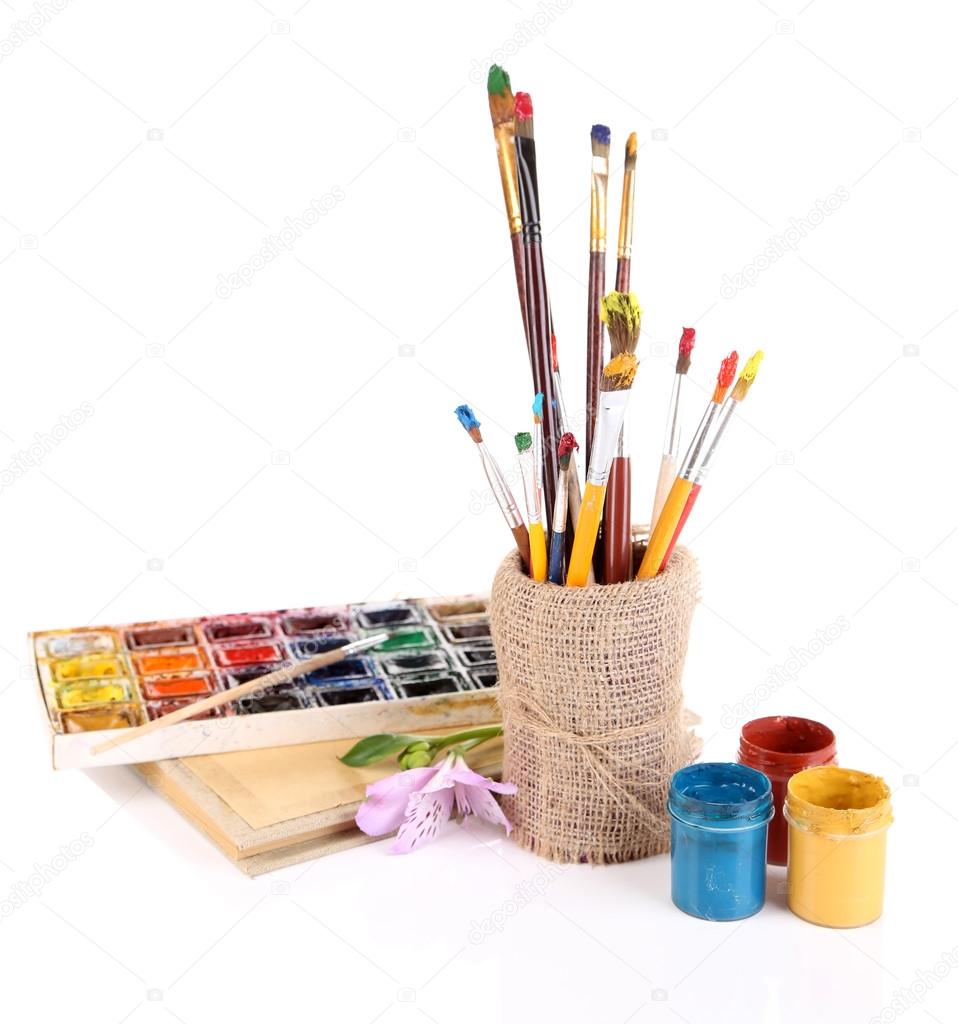 Composition with brushes in vase and paints isolated on white