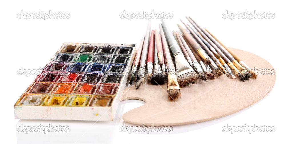 Many brushes on wooden palette, isolated on white
