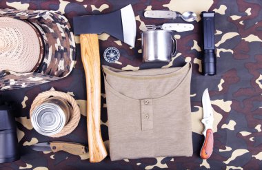 Equipment for trekking on camouflage background clipart