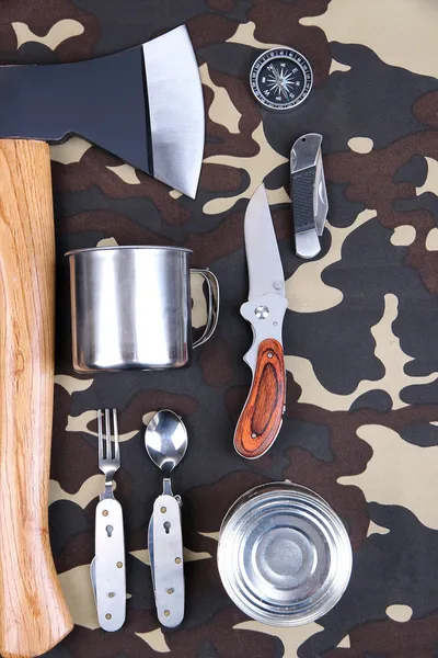 Equipment for trekking on camouflage background — Stock Photo, Image