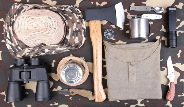 Equipment for trekking on camouflage background — Stock Photo, Image