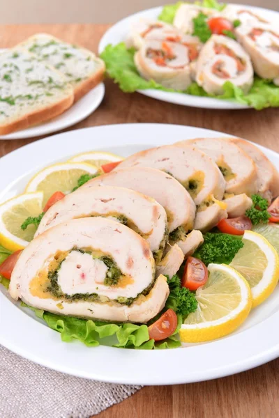 Delicious chicken roll on plate on table close-up — Stock Photo, Image