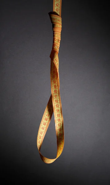 Tape measure noose on grey background - diet concept — Stock Photo, Image
