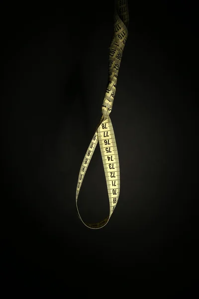 Tape measure noose on black background - diet concept — Stock Photo, Image