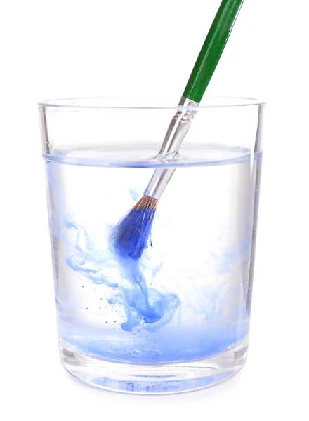 Brush with color paint in glass of water, isolated on white — Stock Photo, Image