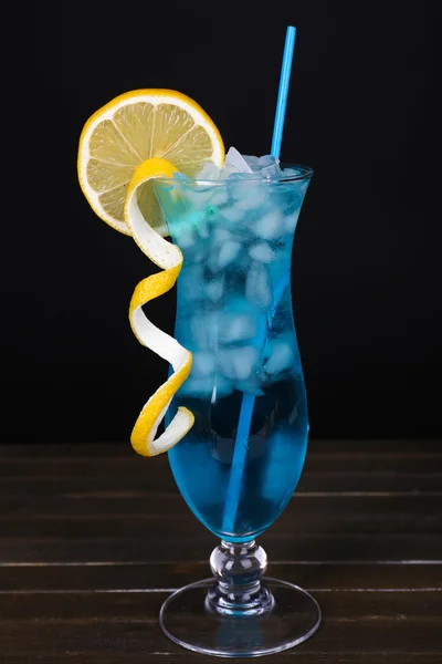 Glass of cocktail on table on black background — Stock Photo, Image