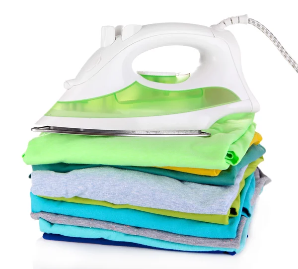 Iron on pile of colorful clothes isolated on white — Stock Photo, Image