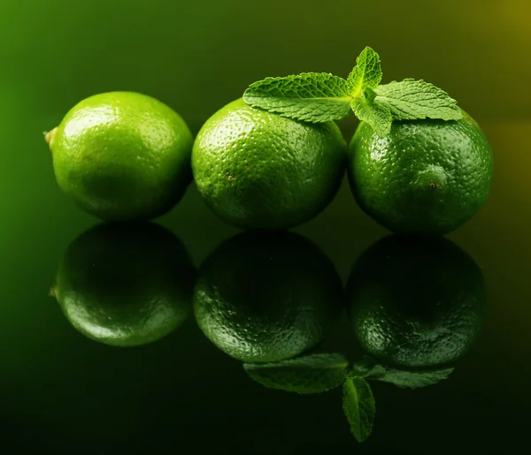 Fresh limes on dark background — Stock Photo, Image