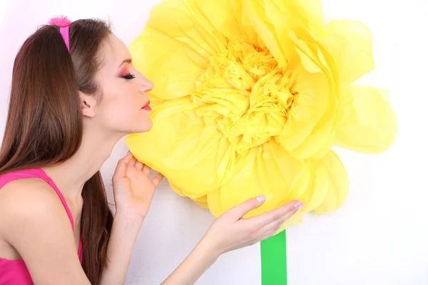 Beautiful young woman in petty skirt with big flower close up — Stock Photo, Image