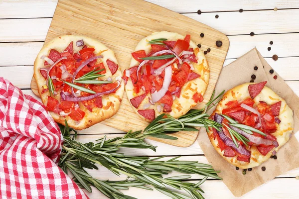 Small pizzas on wooden table close up — Stock Photo, Image