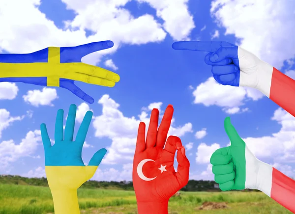 Flag of different countries painted on hand — Stock Photo, Image