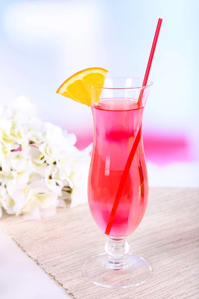 Glass of cocktail on table on light background — Stock Photo, Image