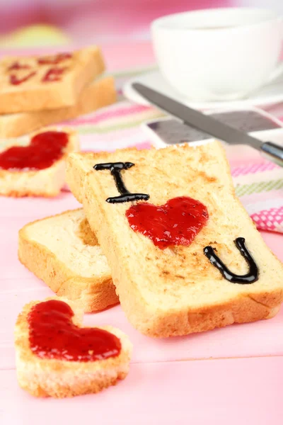 Delicious toast with jam and cup of tea on table close-up — Stock Photo, Image