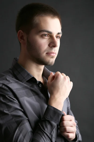 Handsome young man on dark background — Stock Photo, Image