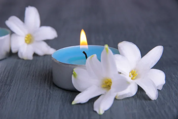 White hyacinth with candle on wooden background — Stock Photo, Image