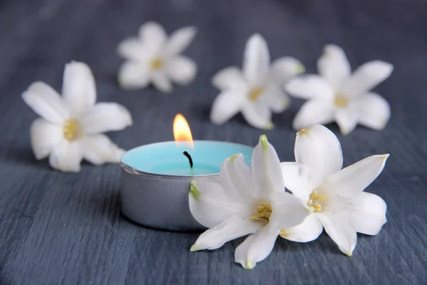 White hyacinth with candle on wooden background — Stock Photo, Image