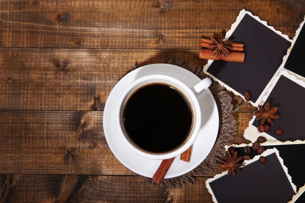 Coffee cup and old blank photos and spices, on wooden background — Stock Photo, Image