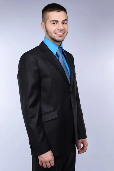 Business man on grey background — Stock Photo, Image
