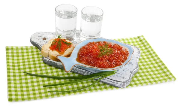 Red caviar in bowl and vodka on wooden board , on napkin isolated on white — Stock Photo, Image