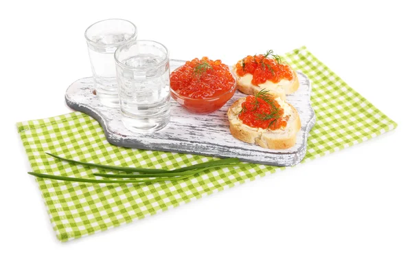 Red caviar in bowl and vodka on wooden board , on napkin isolated on white — Stock Photo, Image