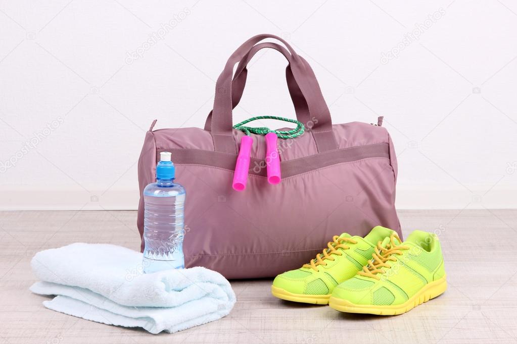 Sports bag with sports equipment in gymnasium