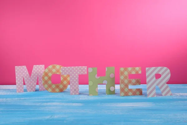 Mother- lettering of handmade paper letters on pink background — Stock Photo, Image