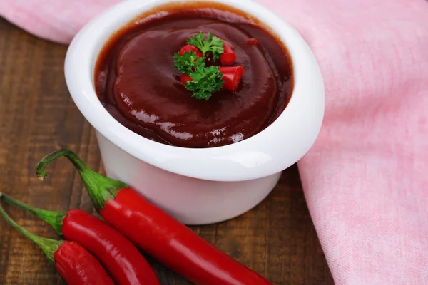 Tomato sauce in bowl on wooden table close-up — Stock Photo, Image