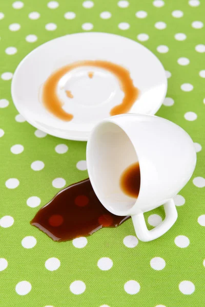 Overturned cup of coffee on table close-up — Stock Photo, Image