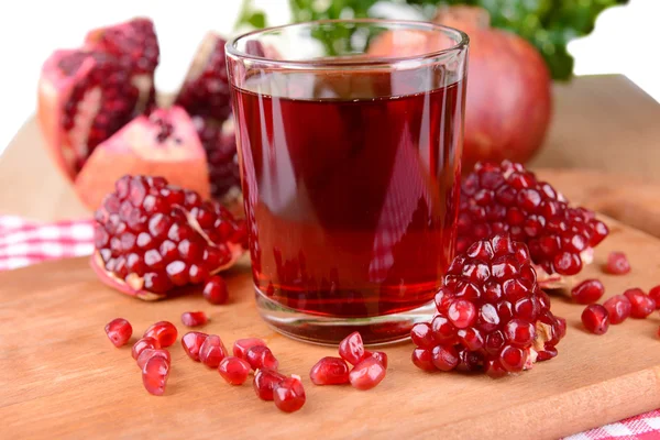 Ripe pomegranates with juice on table close-up — Stock Photo, Image