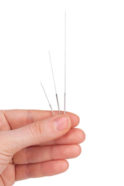 Hand holding needles for acupuncture on hand, close up. Isolated on white — Stock Photo, Image