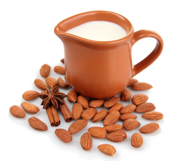 Almond milk in jug with almonds, isolated on white — Stock Photo, Image