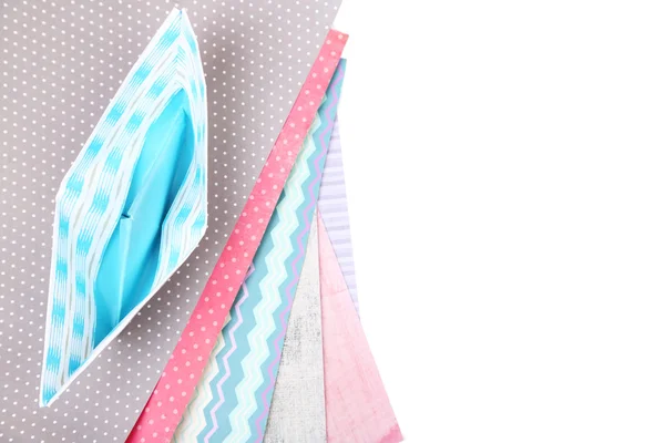 Origami tekne ve renkli kağıtlar üzerine beyaz izole — Stok fotoğraf