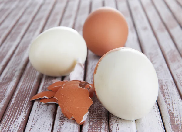 Peeled boiled egg on wooden background — Stock Photo, Image