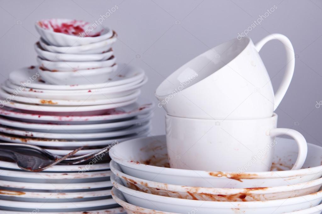 Dirty dishes on gray background