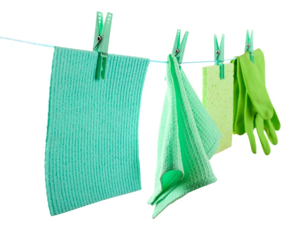 Kitchen sponges and rubber gloves hanging on rope isolated on white — Stock Photo, Image