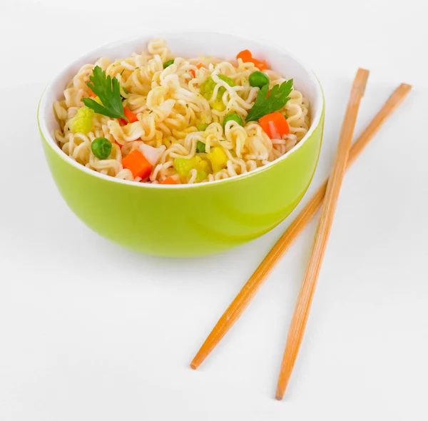 Sabrosos fideos instantáneos con verduras en tazón aislado en blanco — Foto de Stock