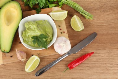 ahşap masa üzerinde kase taze guacamole