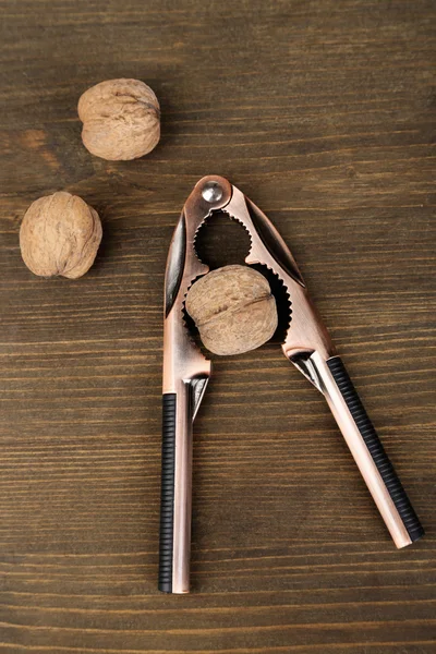 Nutcracker and walnuts isolated on white background — Stock Photo, Image