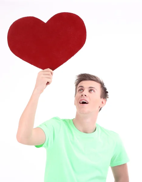 Joven guapo con gran corazón rojo, aislado en blanco — Foto de Stock