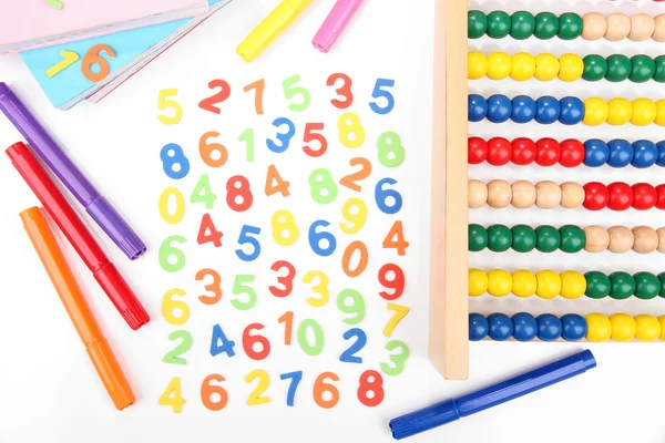 Kleurrijke getallen, abacus, boeken en markeringen, geïsoleerd op wit — Stockfoto