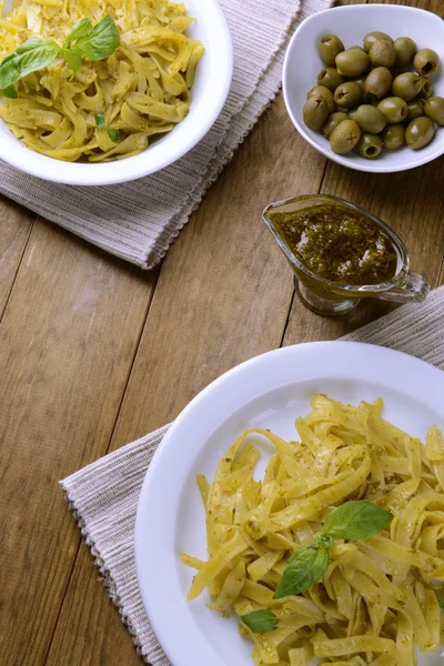 Delicious pasta with pesto on plate on table close-up — Stock Photo, Image