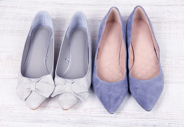 Beautiful grey female shoes on wooden background — Stock Photo, Image
