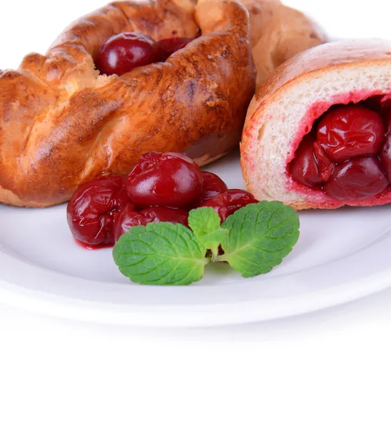 Fresh baked pasties with cherry on plate close-up — Stock Photo, Image
