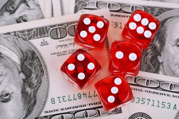 Red dices on dollars background — Stock Photo, Image