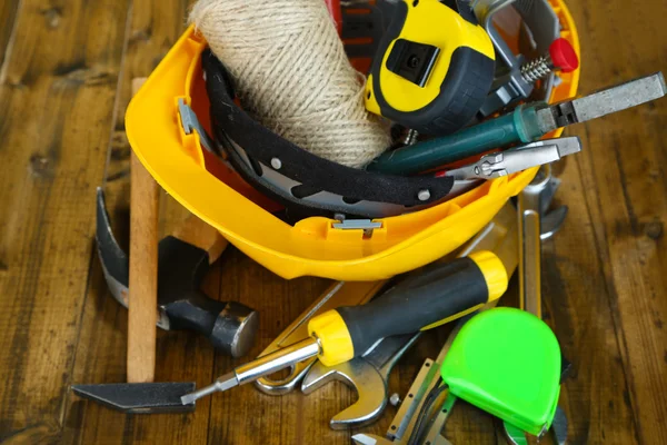 Construction equipment on wooden background — Stock Photo, Image